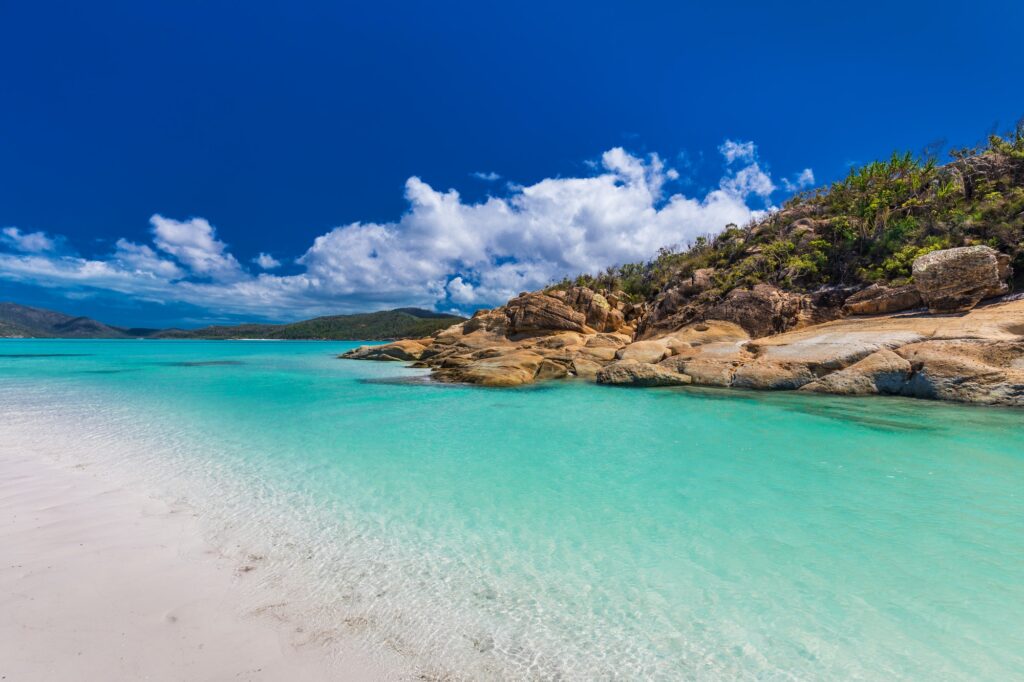 Rocks on Whitehaven Beach with white sand in the Whitsunday Isla